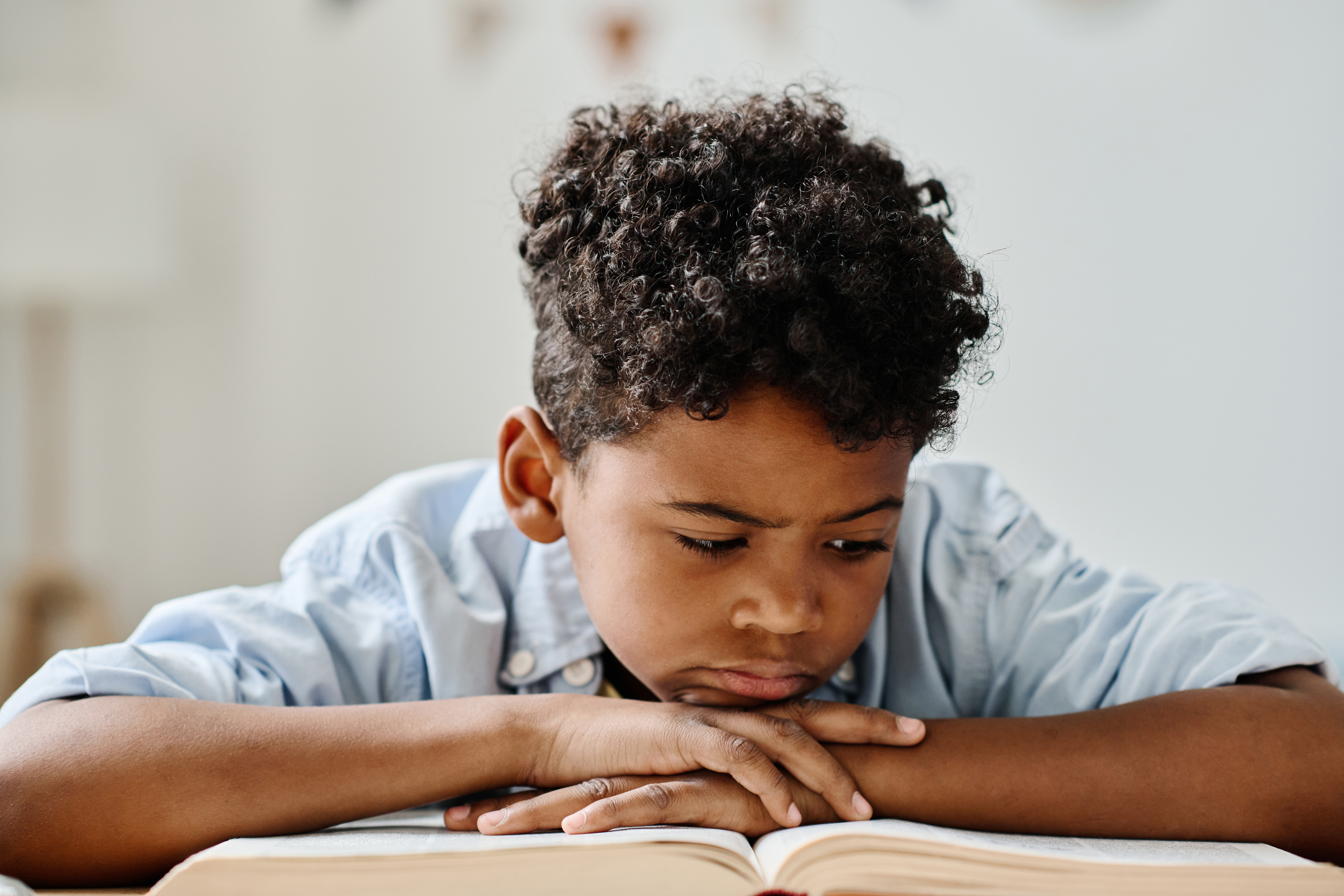 Boy concentrating while reading a book