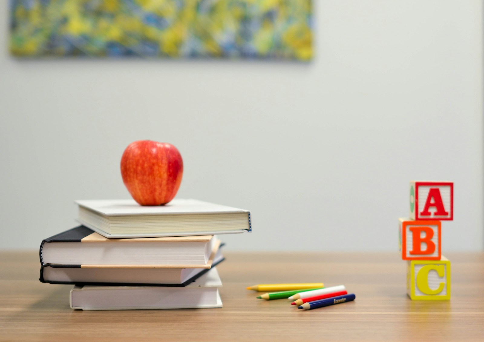 Books, pencils, and alphabet blocks set out for a child's learning time