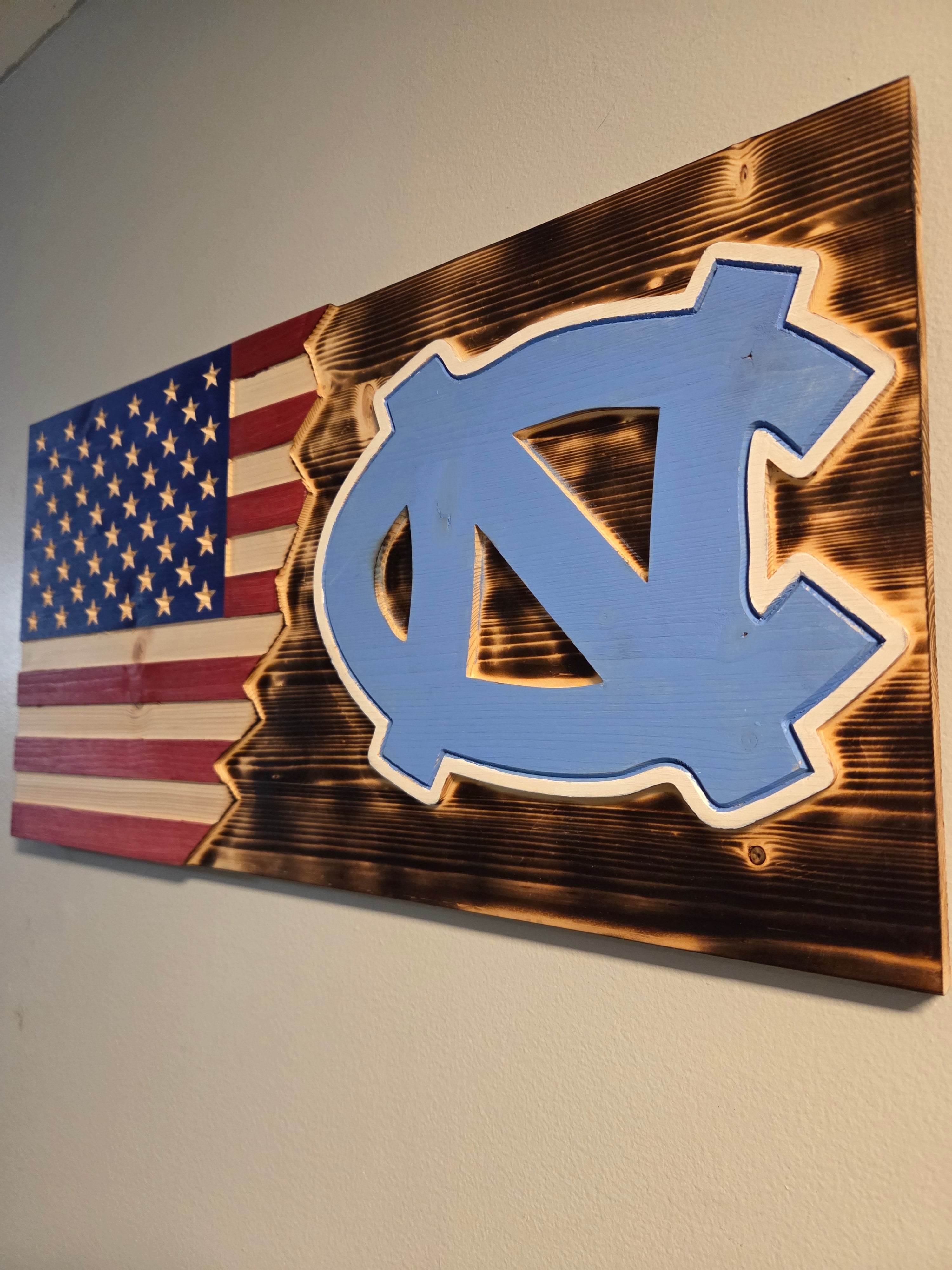 Handcrafted UNC wooden American flag with visible carved stars and wood grain