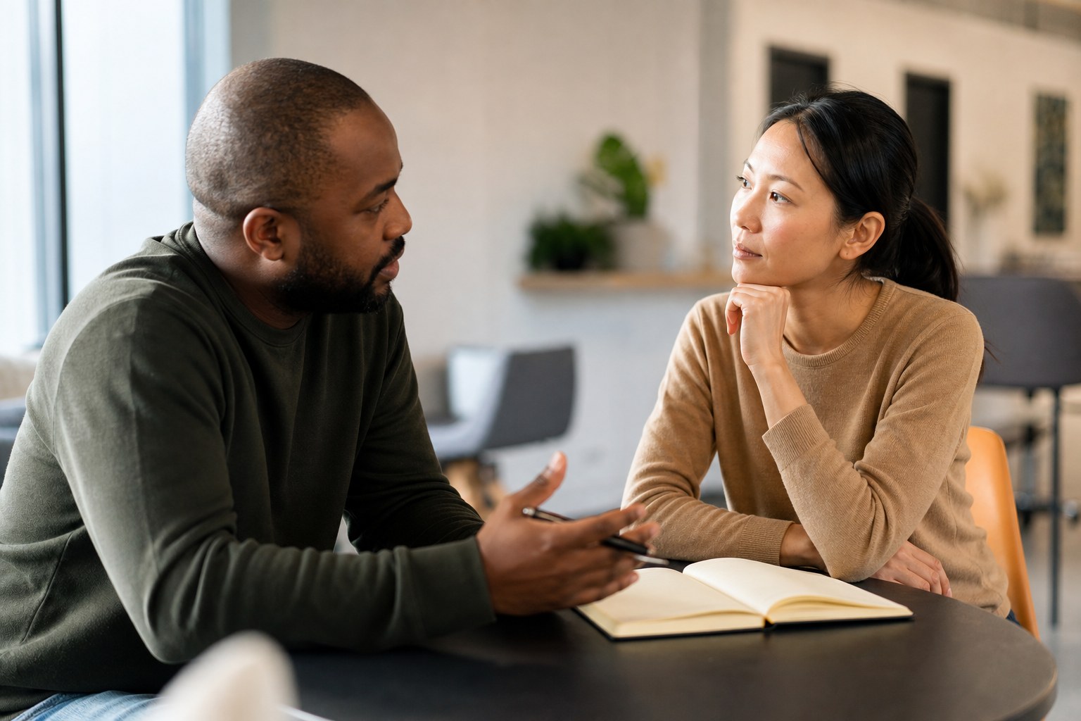Two colleagues in a focused feedback conversation