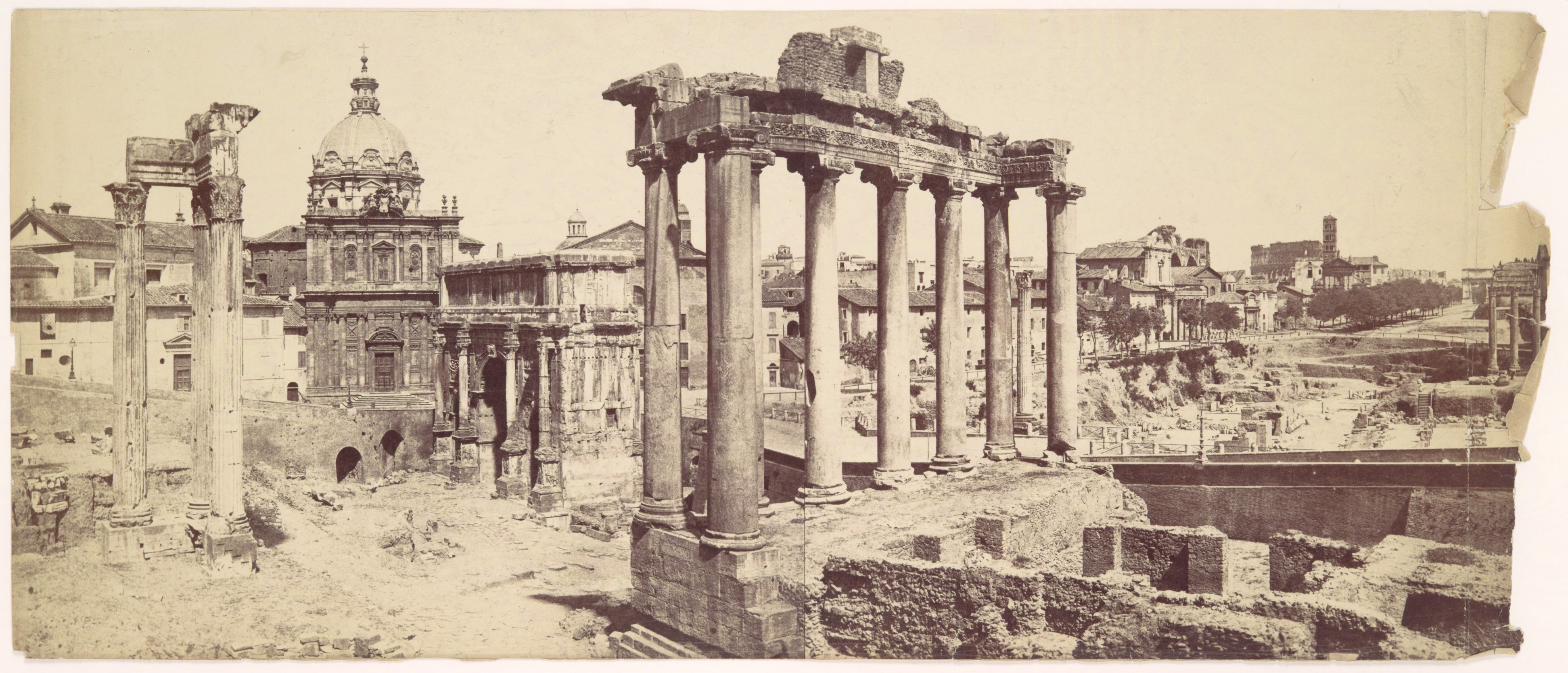 Historic photograph of the Roman Forum with columns and a church dome
