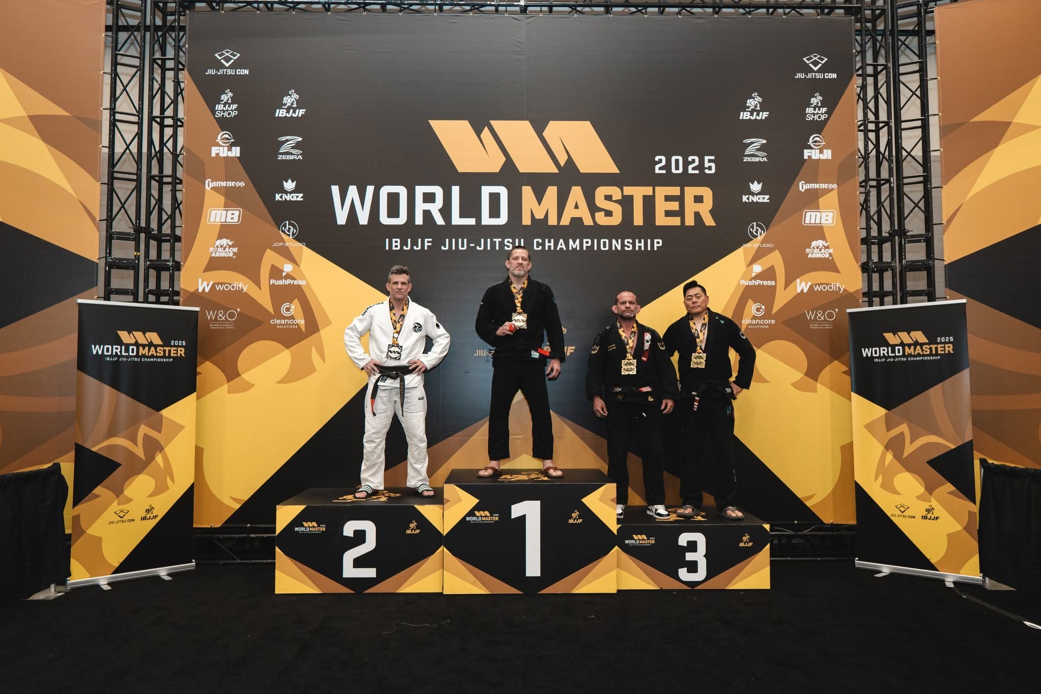 Ishmael Trent Draper standing on the first-place podium at the 2025 World Master Jiu-Jitsu Championship