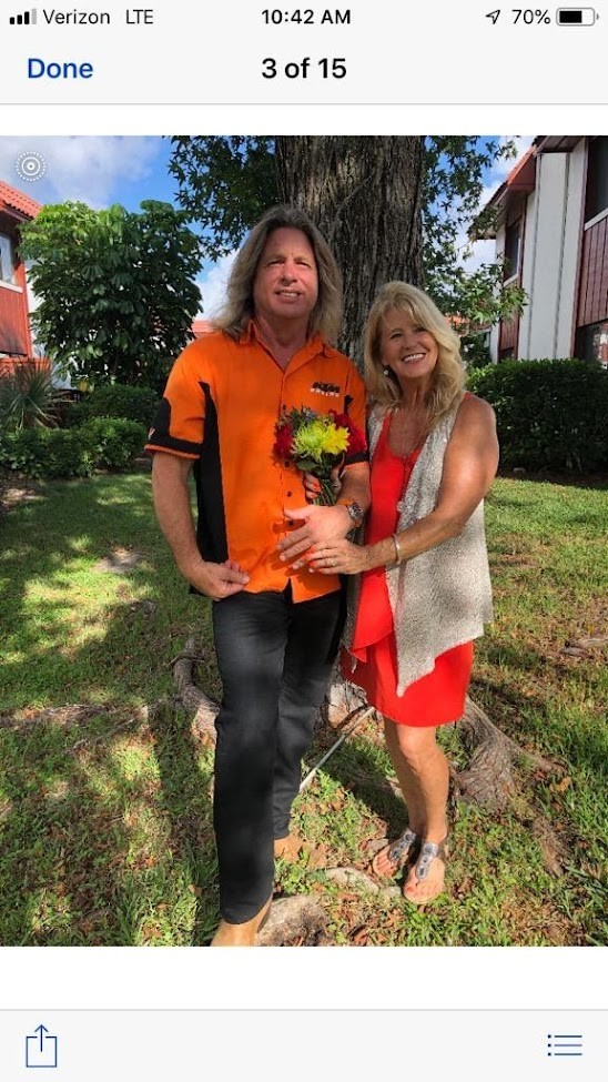 Couple celebrating outdoors with a bouquet