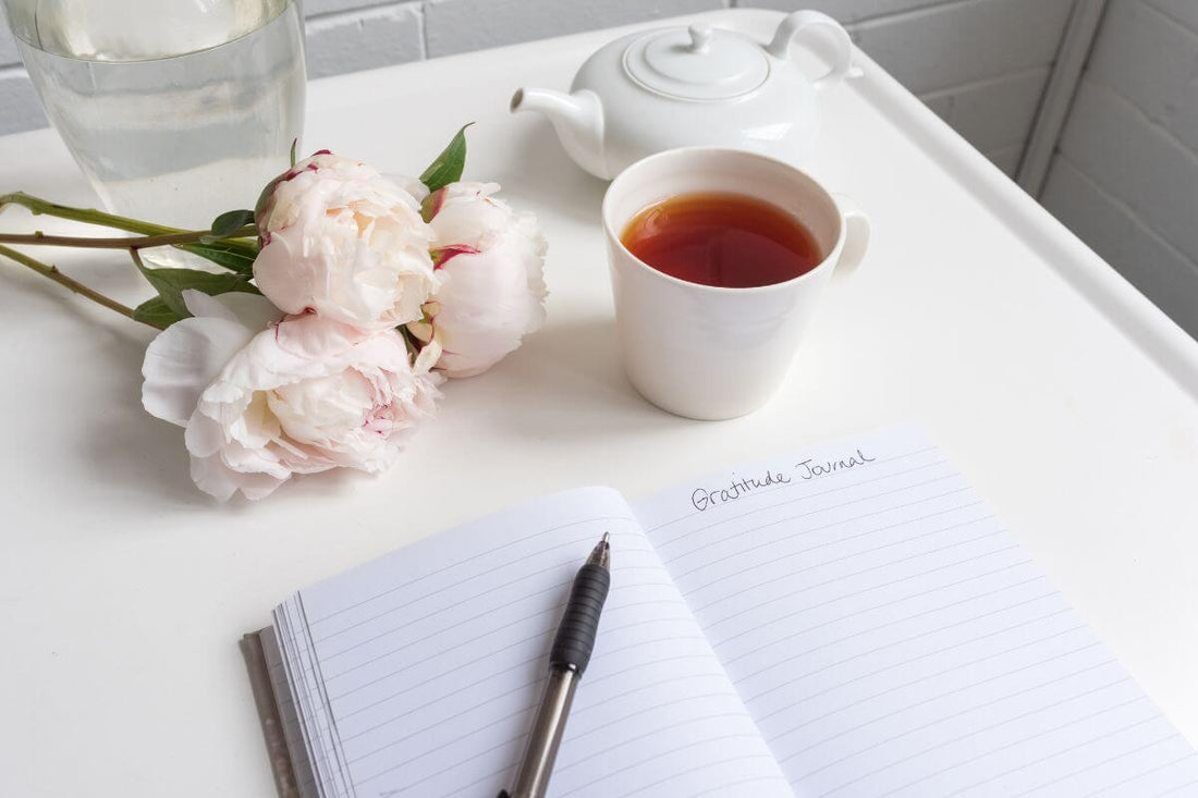 A journal and tea set out for a quiet reflection