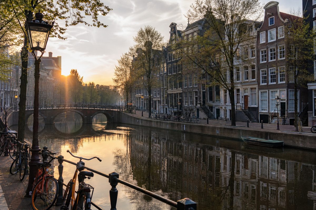 Amsterdam canal with bicycles and historic townhouses