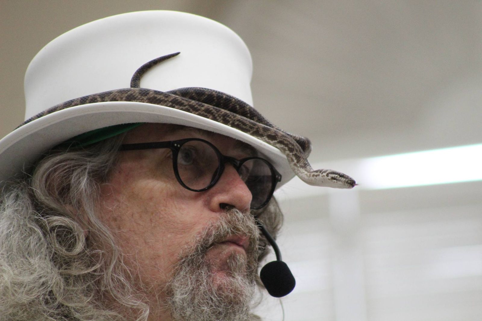 Daryl Sprout wearing a white hat with Louise the snake resting along its brim