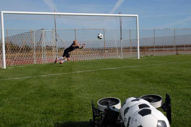 Goalkeepers training with a soccer ball