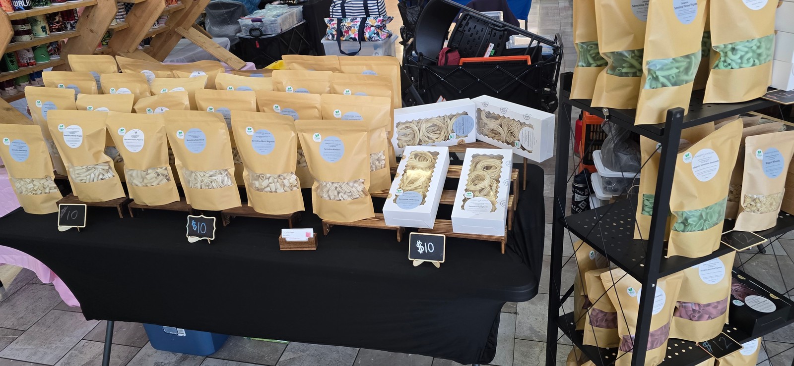 Handmade pasta bags and gift boxes on the Homestyle Dough market table
