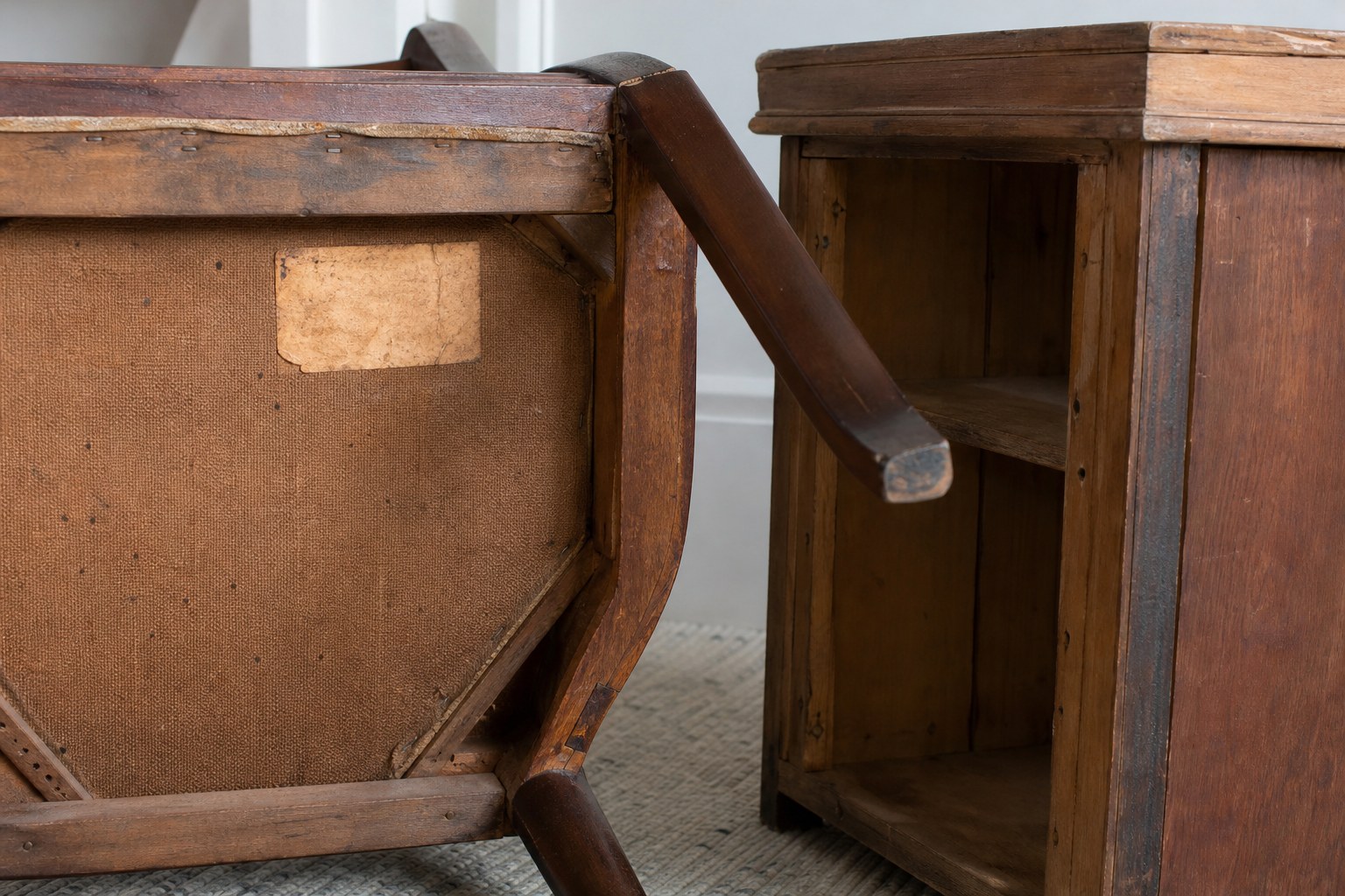 Underside of vintage wood furniture showing construction and an old paper label