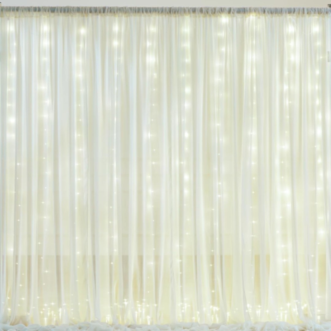 Ivory Sheer Drapes with Fairy Lights backdrop available from The Pose Garden