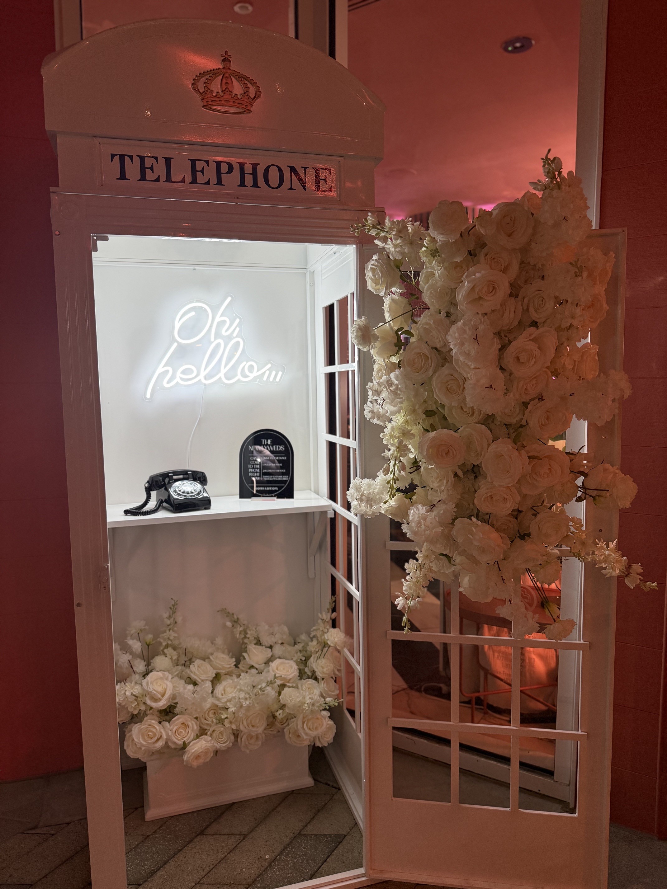 London-style telephone booth with floral audio guestbook at a Phoenix wedding