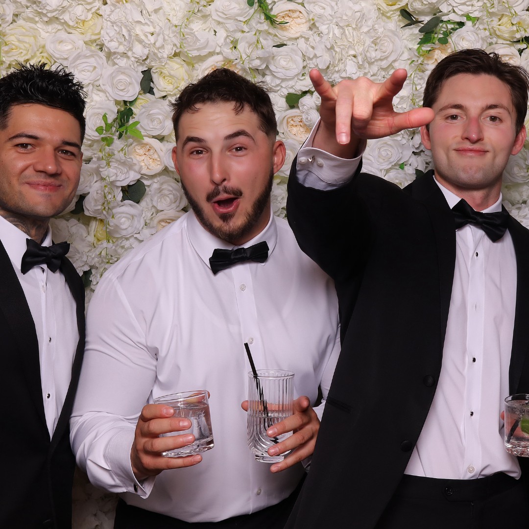 Wedding guests having fun in The Pose Garden photo booth at a Phoenix wedding