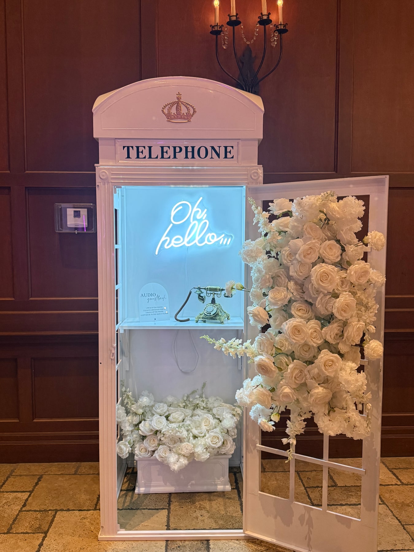 Floral audio guestbook telephone booth at a wedding reception