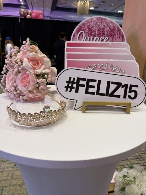 Feliz 15 photo booth prop with tiara and pink flowers for a Phoenix quinceañera celebration