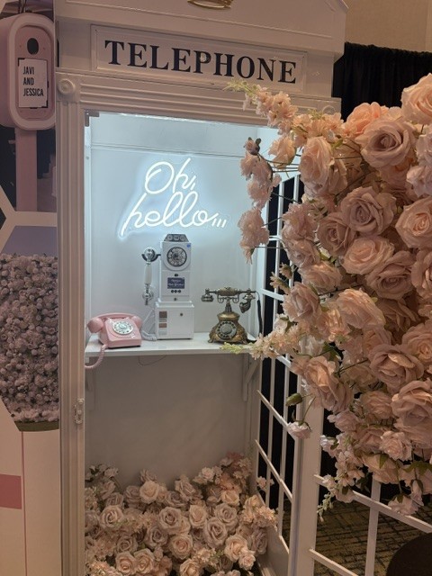 London-style telephone audio guestbook booth with pink flowers and vintage phones for a Phoenix quinceañera
