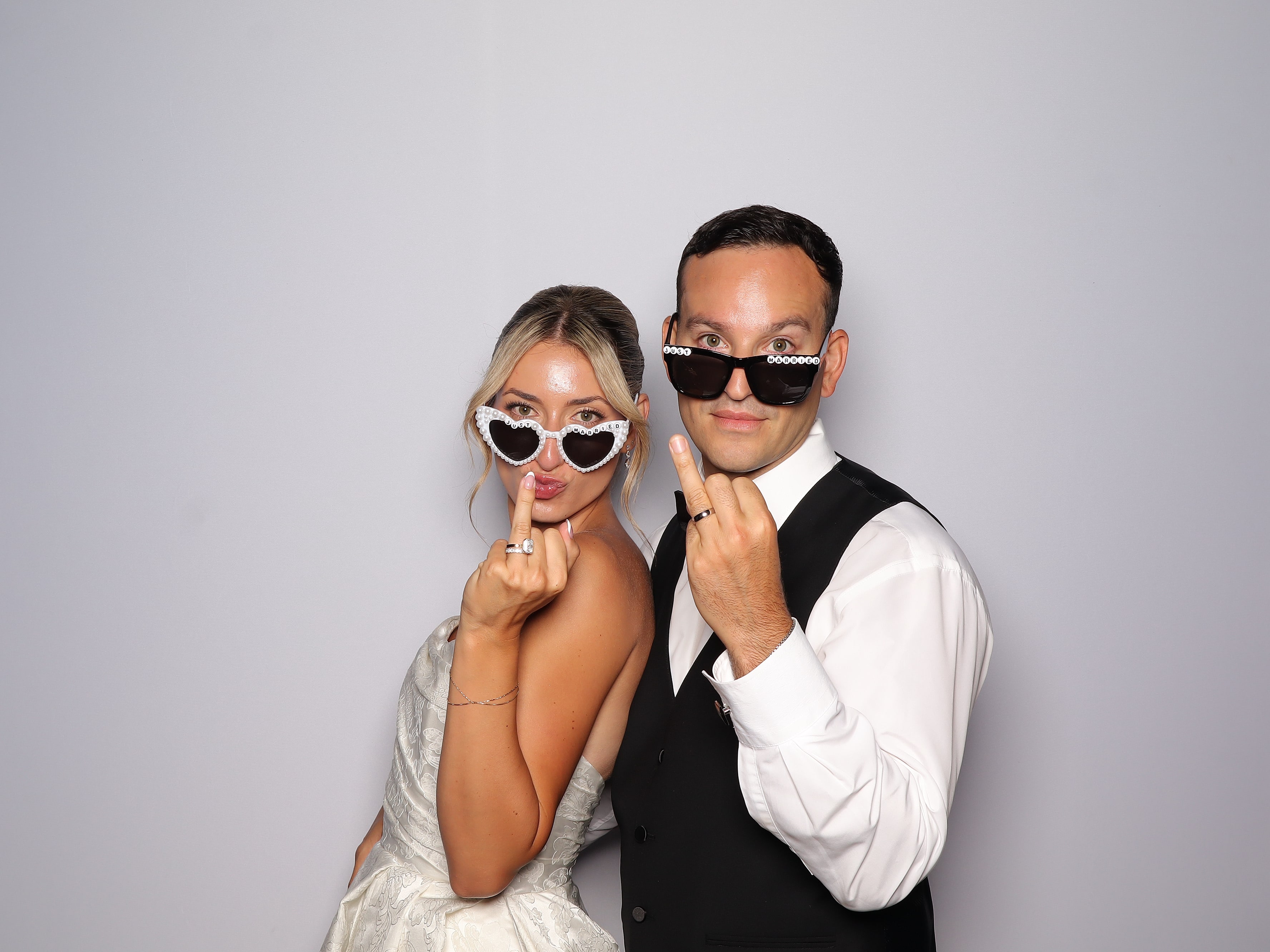 Two guests posing with playful sunglasses in a Photo Booth
