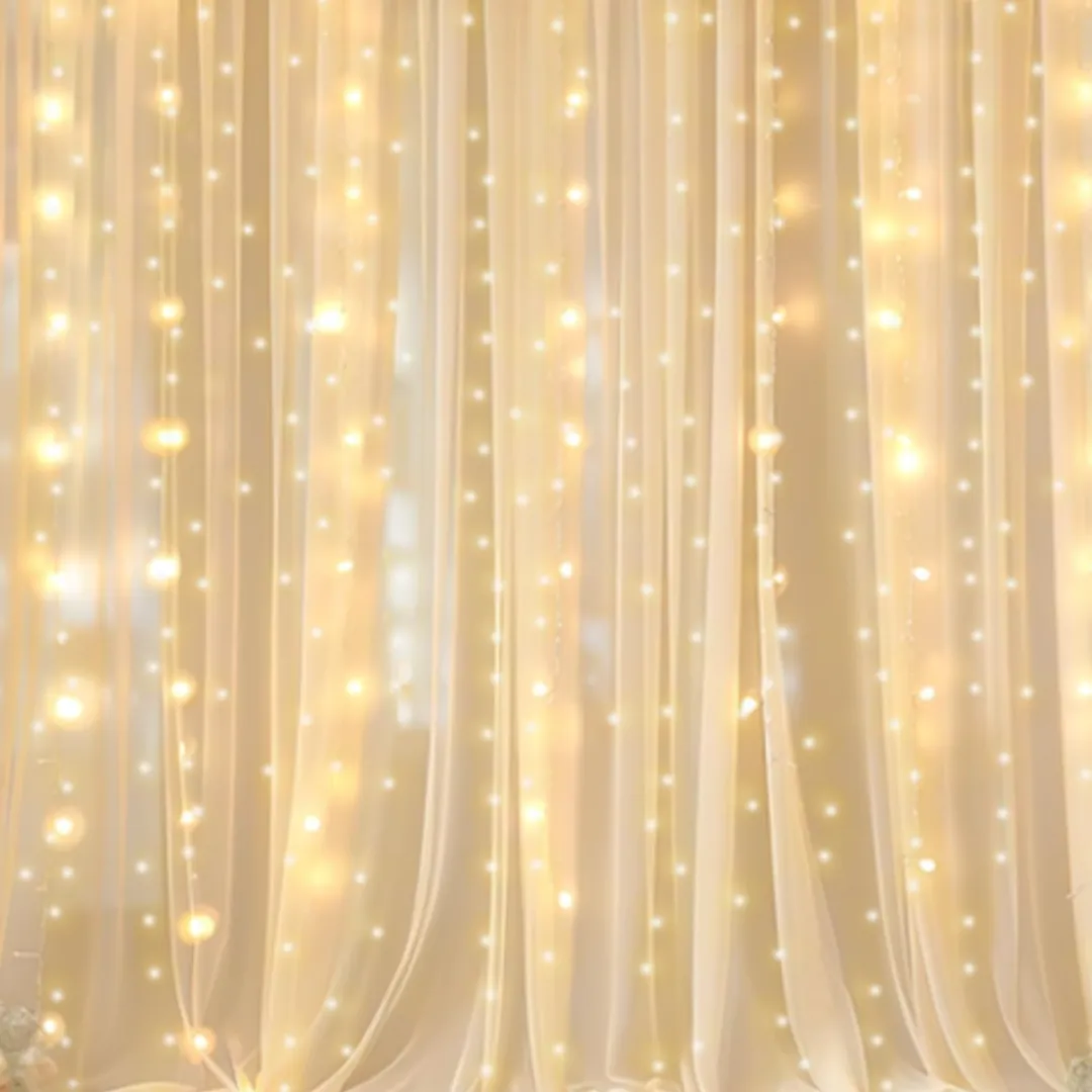 Champagne sheer fabric backdrop with fairy lights