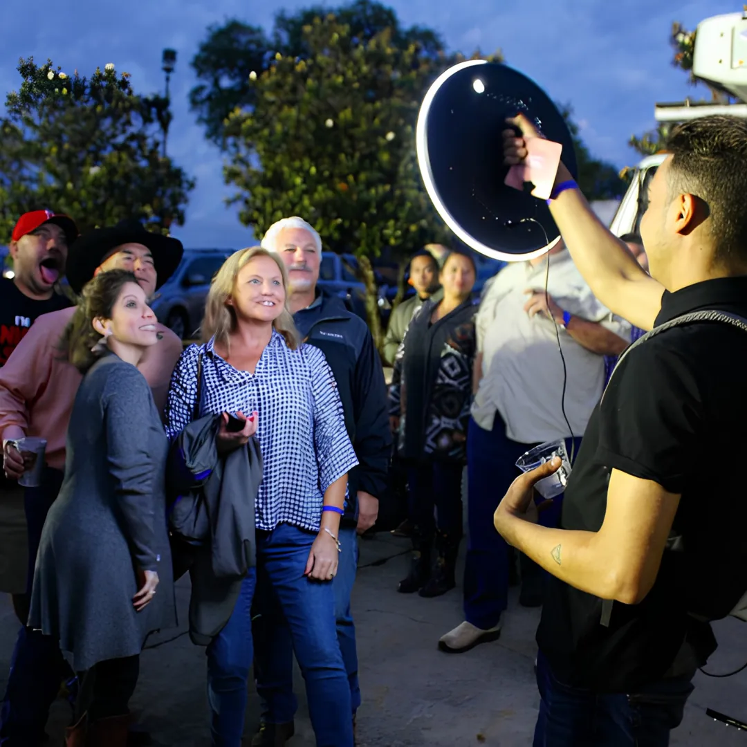 Roaming photo booth attendant taking a photo outdoors