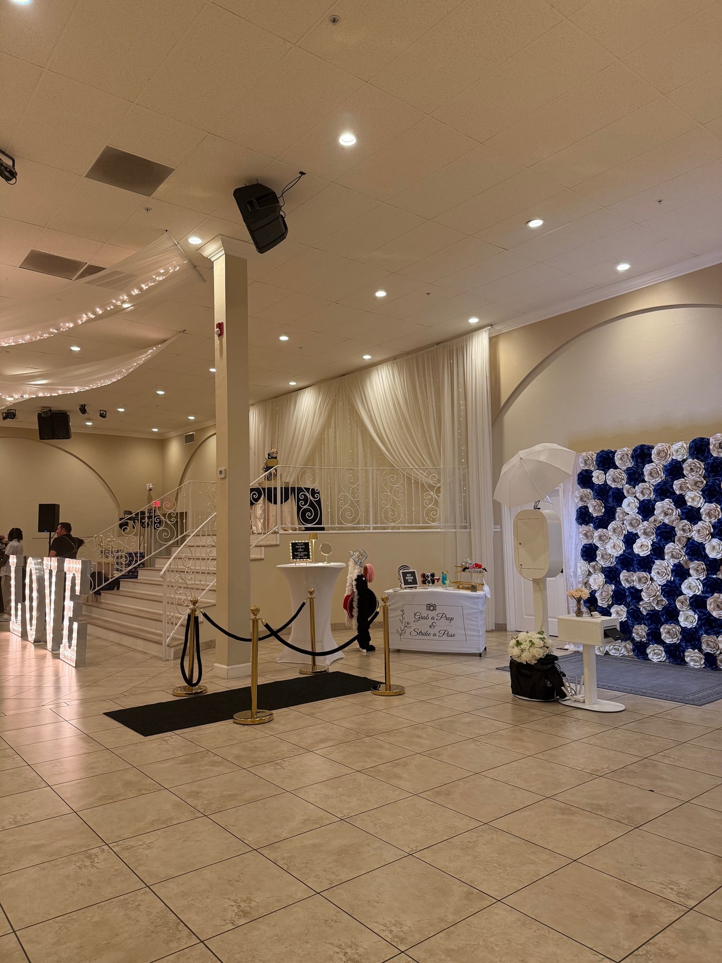 Photo Booth and navy-and-white flower wall at a ballroom reception