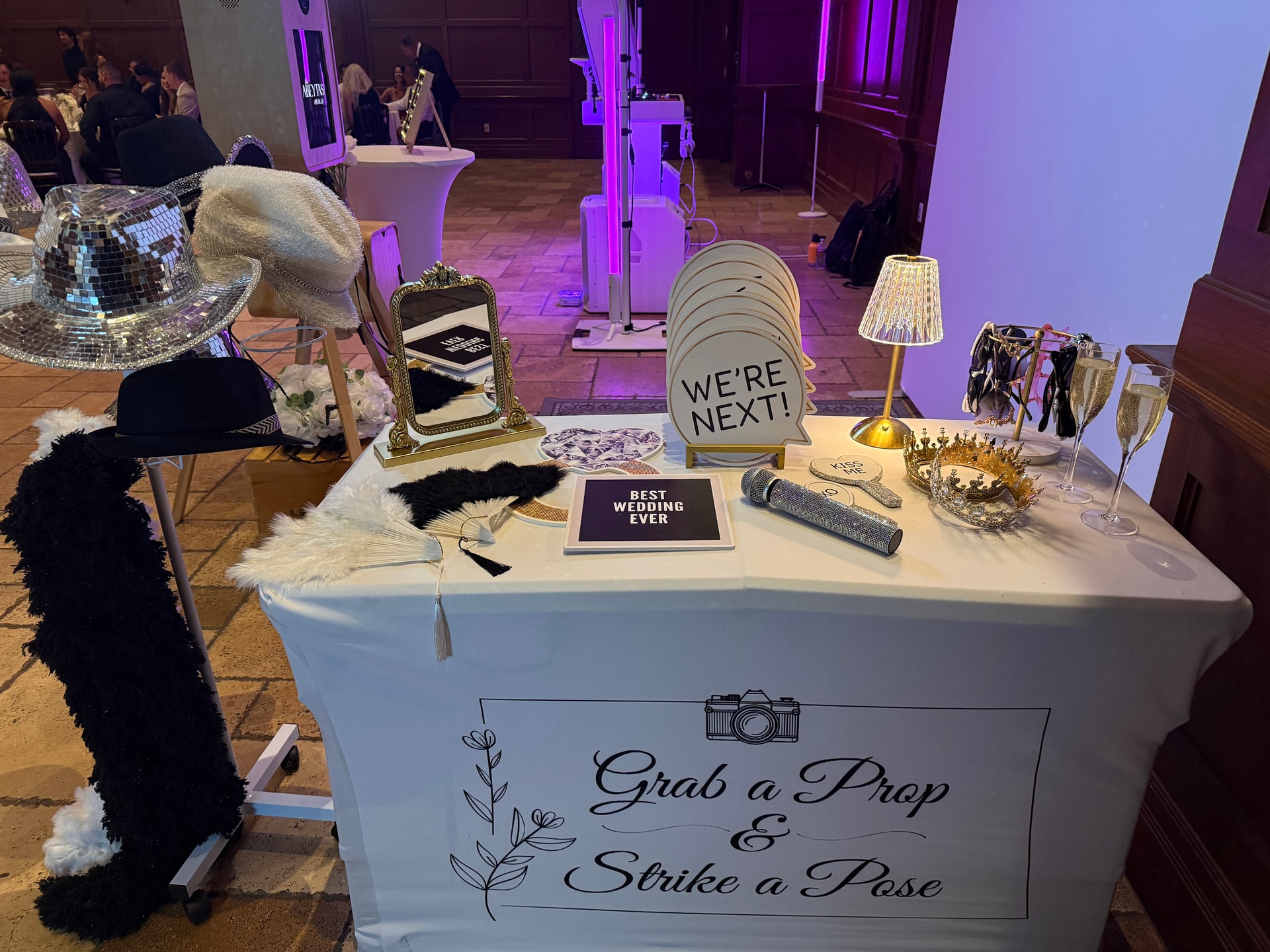 Wedding Photo Booth prop table with hats, accessories and personalized details