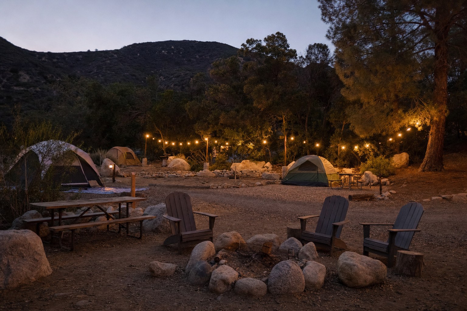 Prepared tent sites and a shared fire circle at an independent campground at dusk