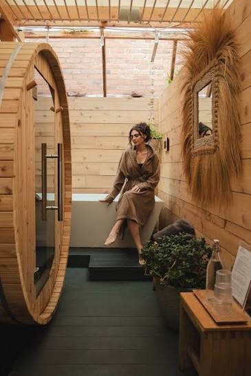 Homeowner stepping out to an outdoor sauna and cold plunge setup
