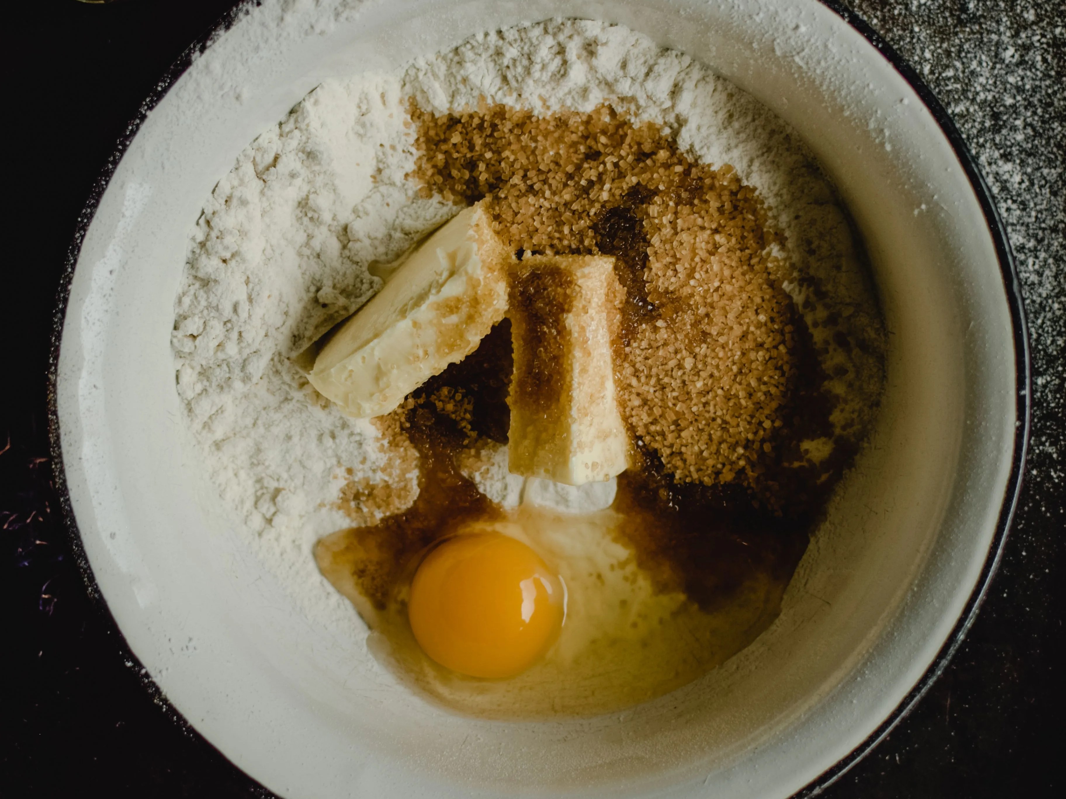 Flour, butter, sugar, and an egg ready for baking