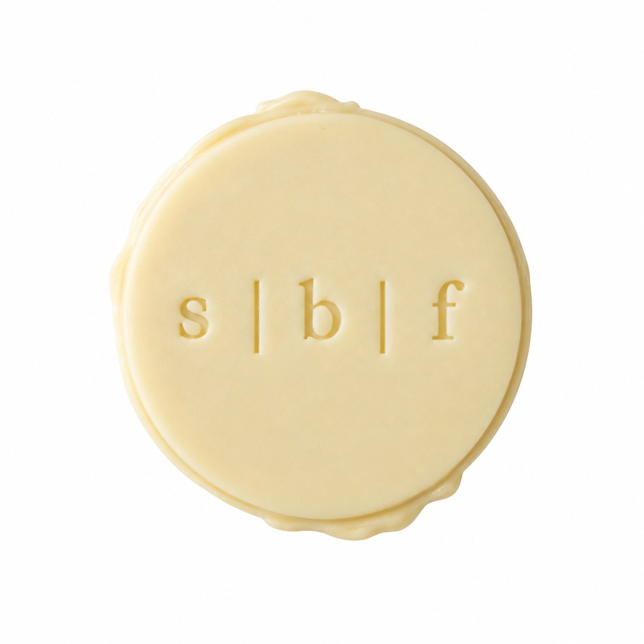 A round white chocolate seal on a bright white background