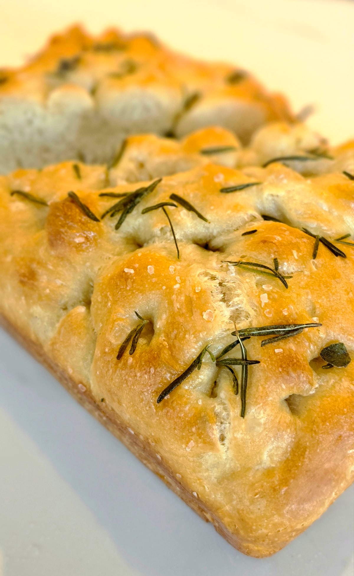 Freshly baked rosemary focaccia with a golden crust and airy crumb