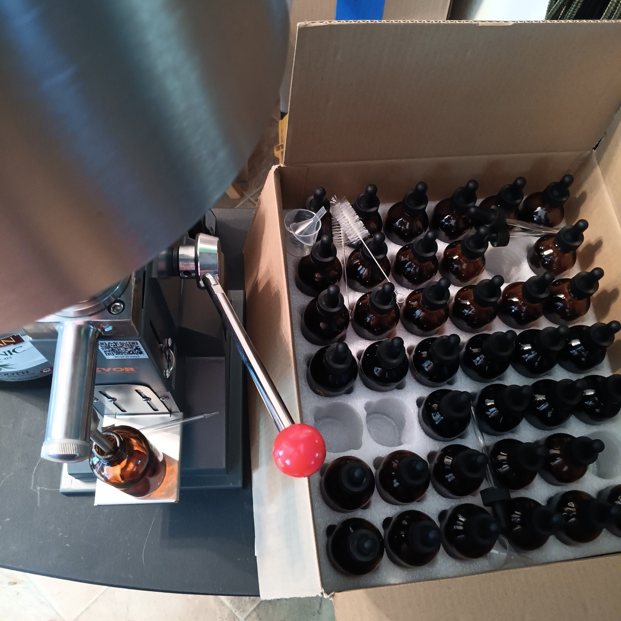 A bottle being filled by hand