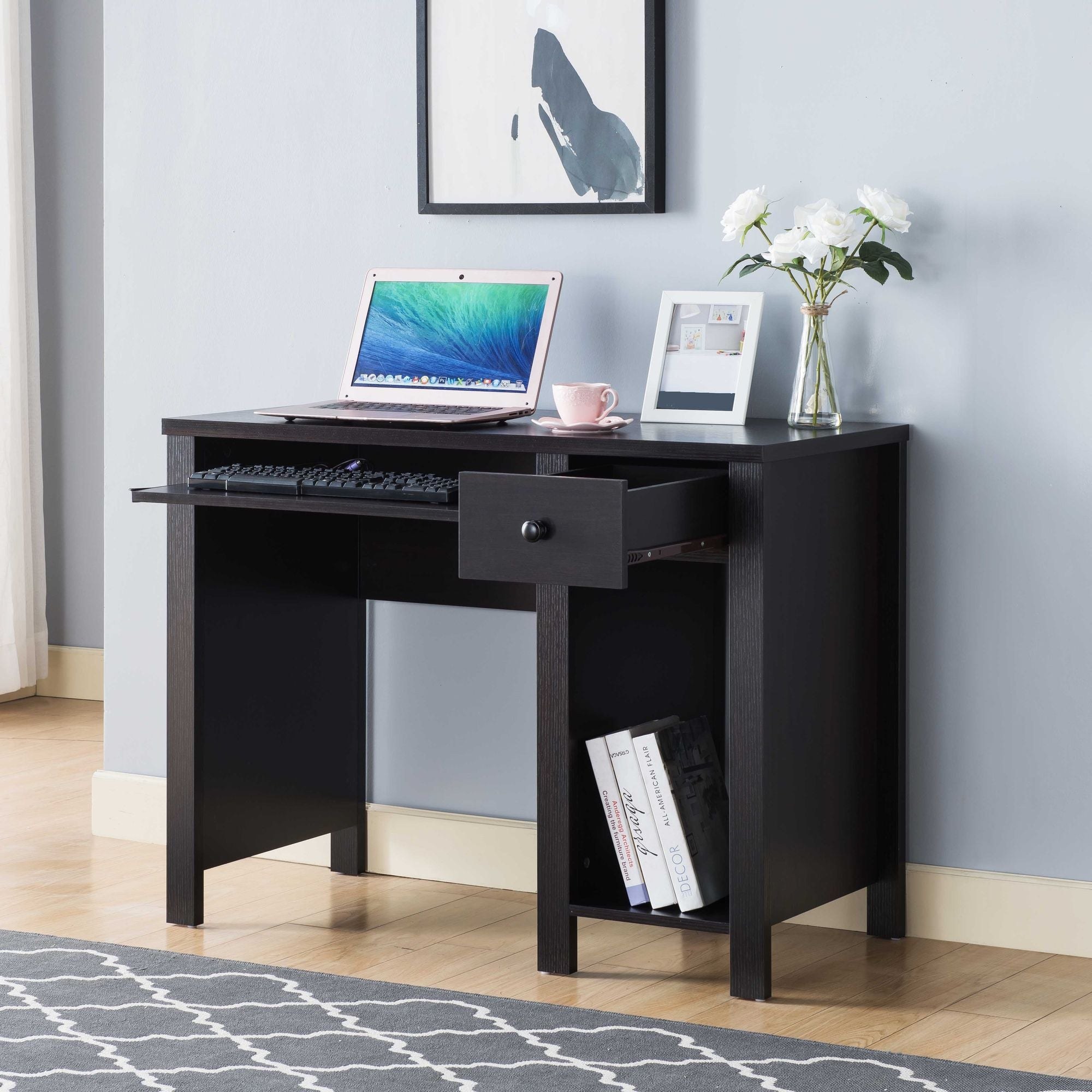 Compact writing desk with a drawer for keeping a gaming setup organized