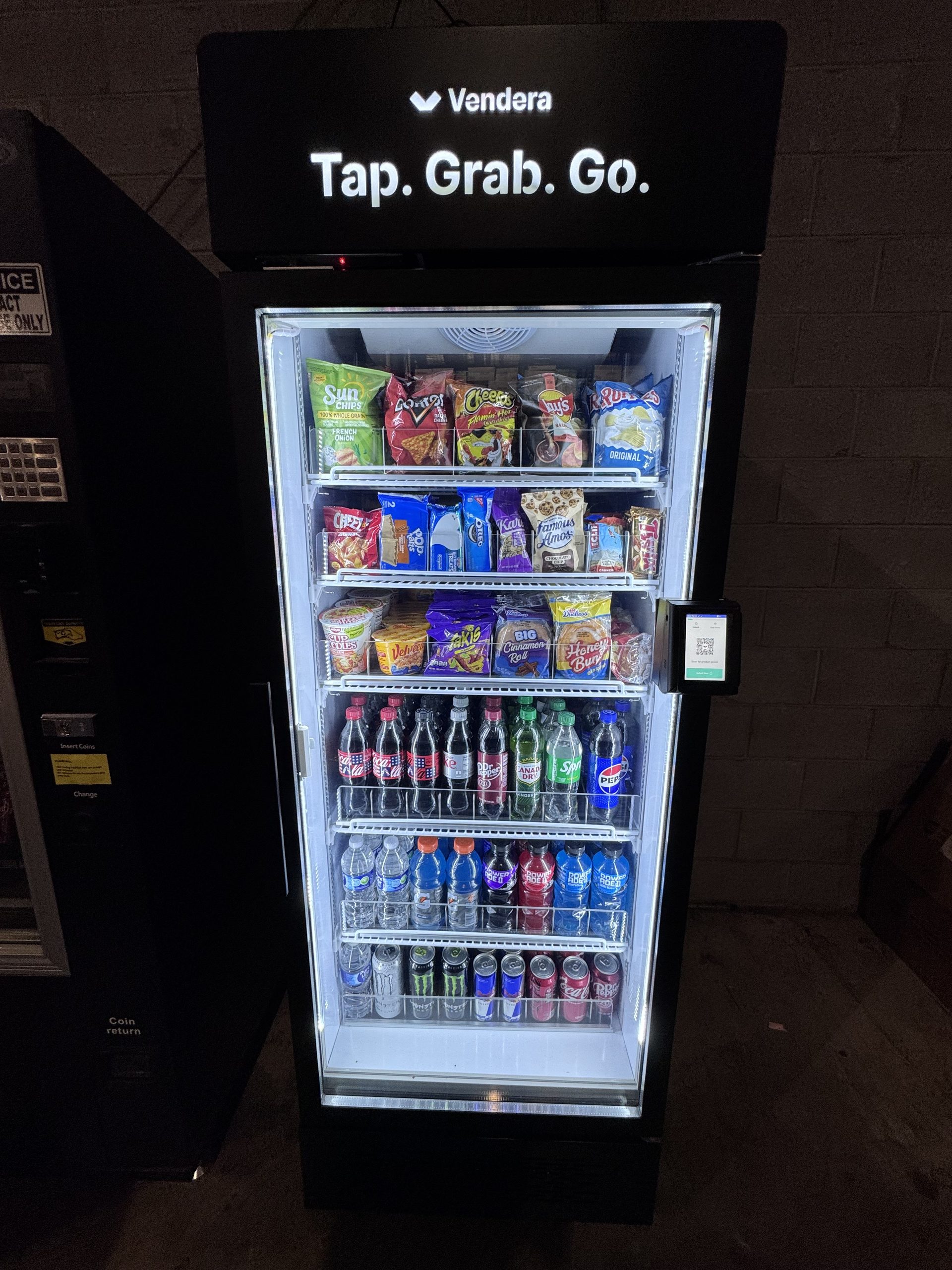 Detail of a stocked commercial smart cooler with refrigerated beverages