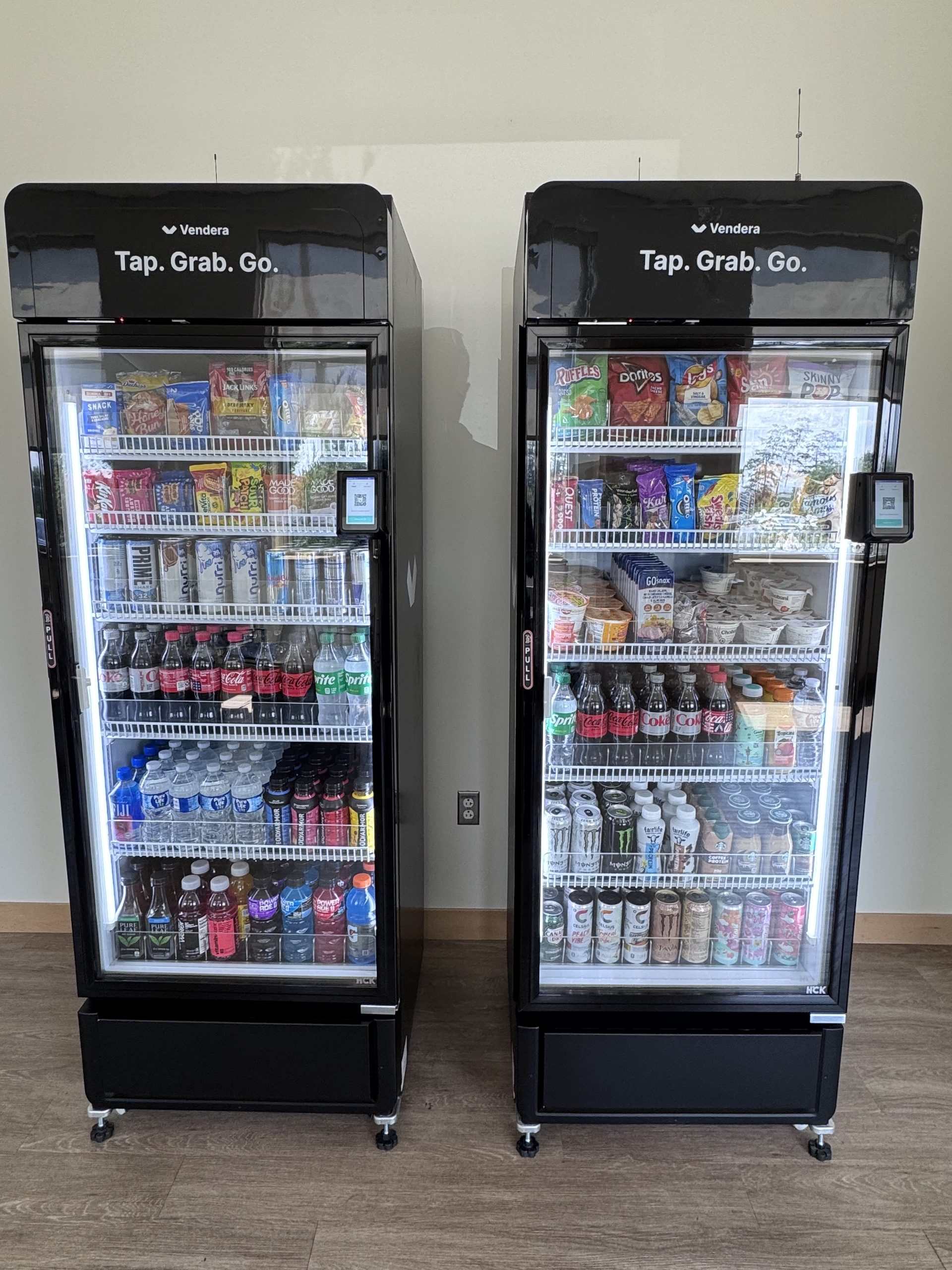 Two stocked commercial smart coolers in a workplace setting