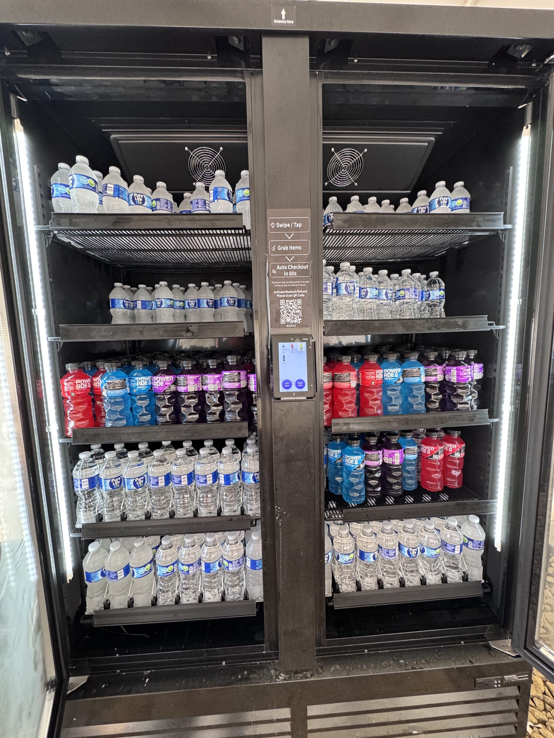Commercial refrigerated hydration equipment stocked with water and sports drinks
