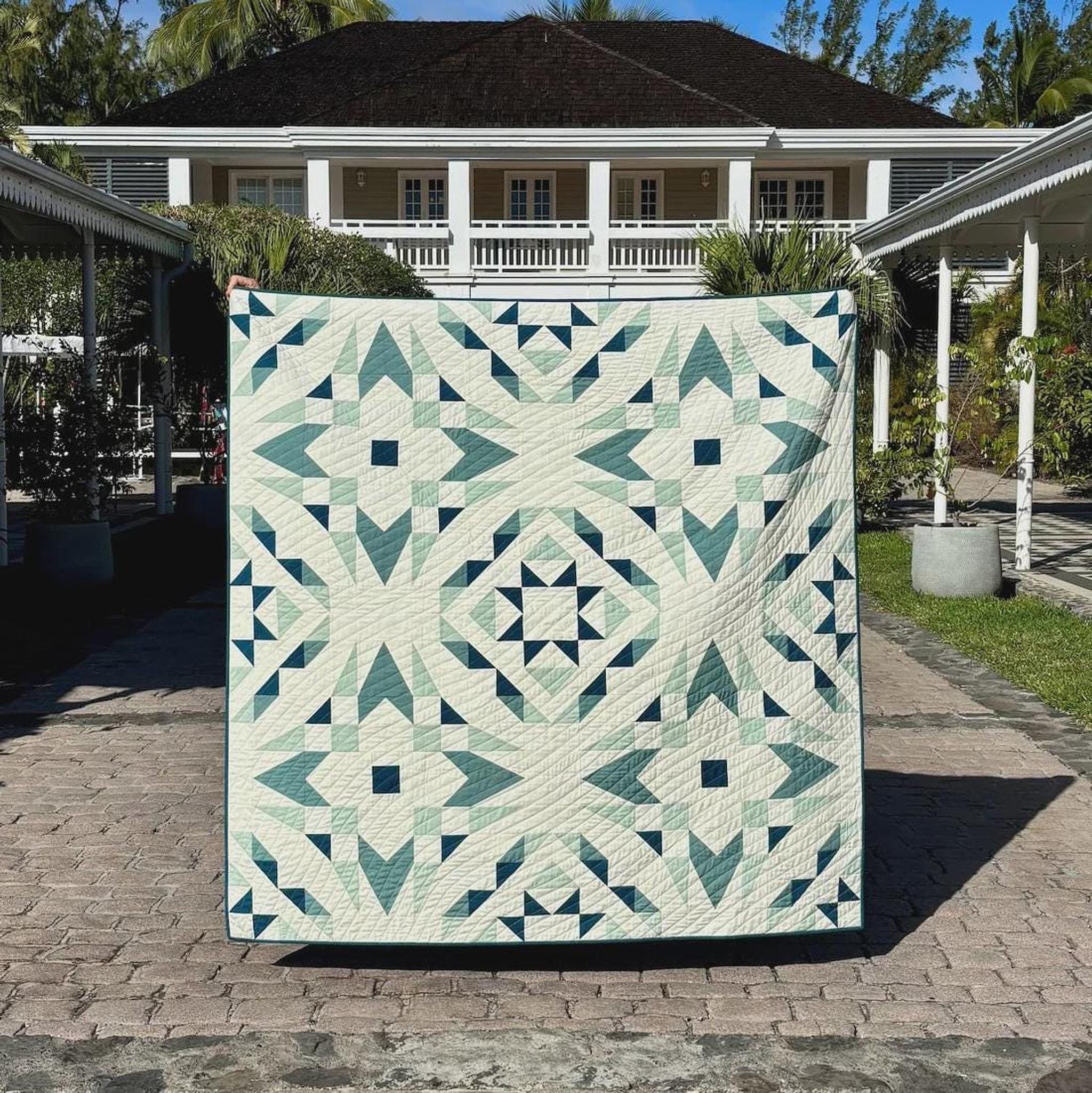 A finished quilt with a neatly framed patchwork design