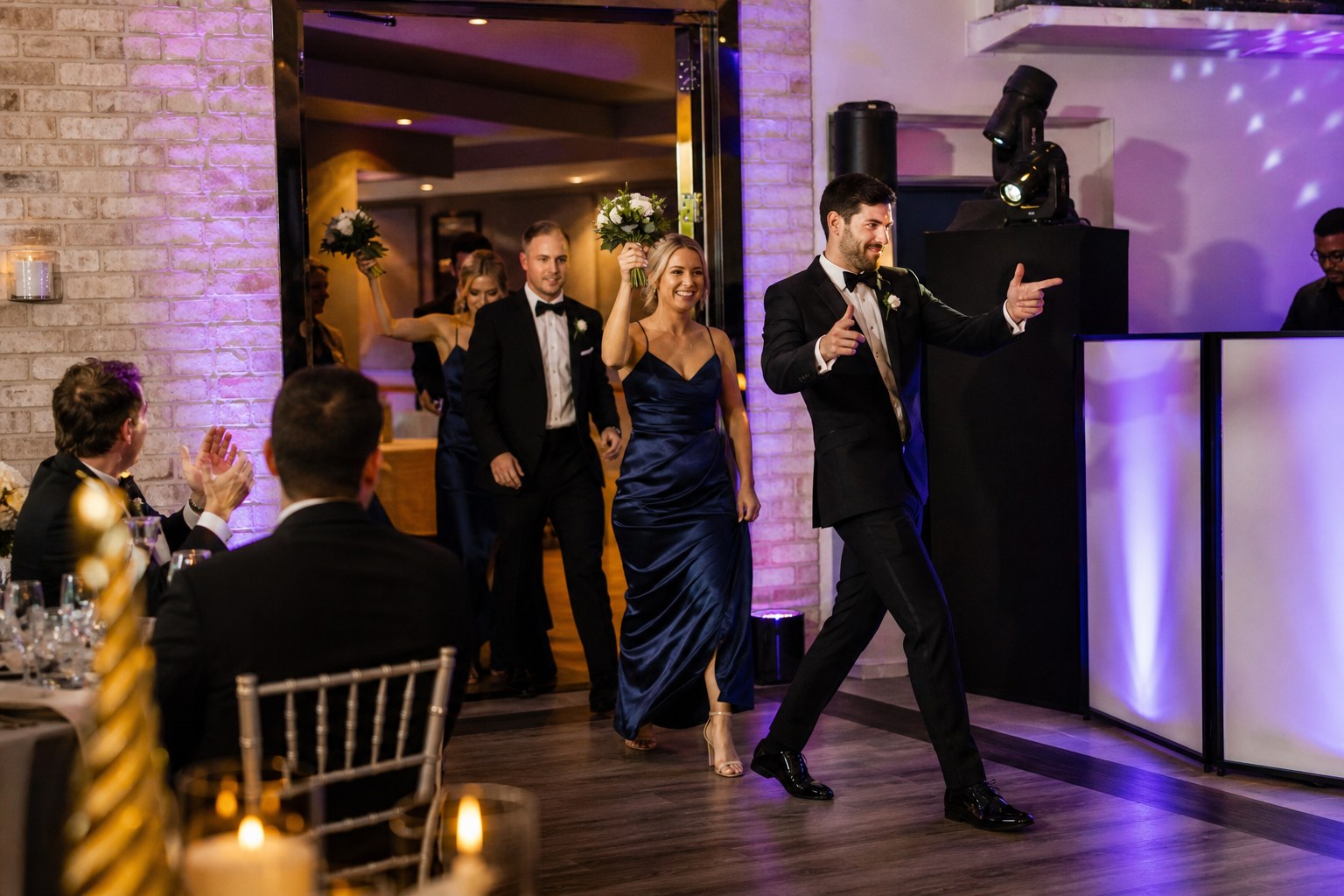 Wedding party making an energetic reception entrance