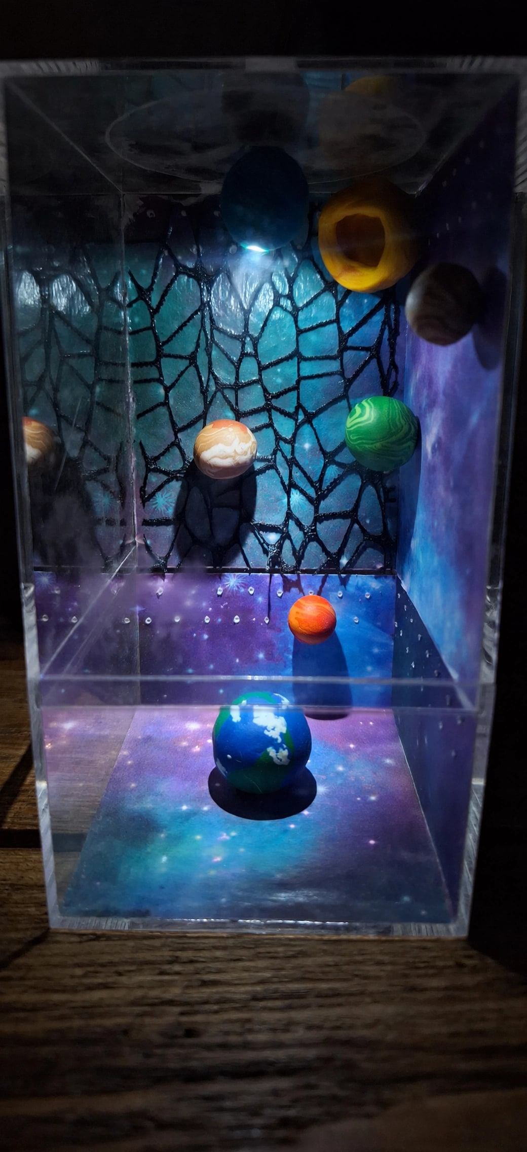 A handmade galaxy-themed jumping spider enclosure