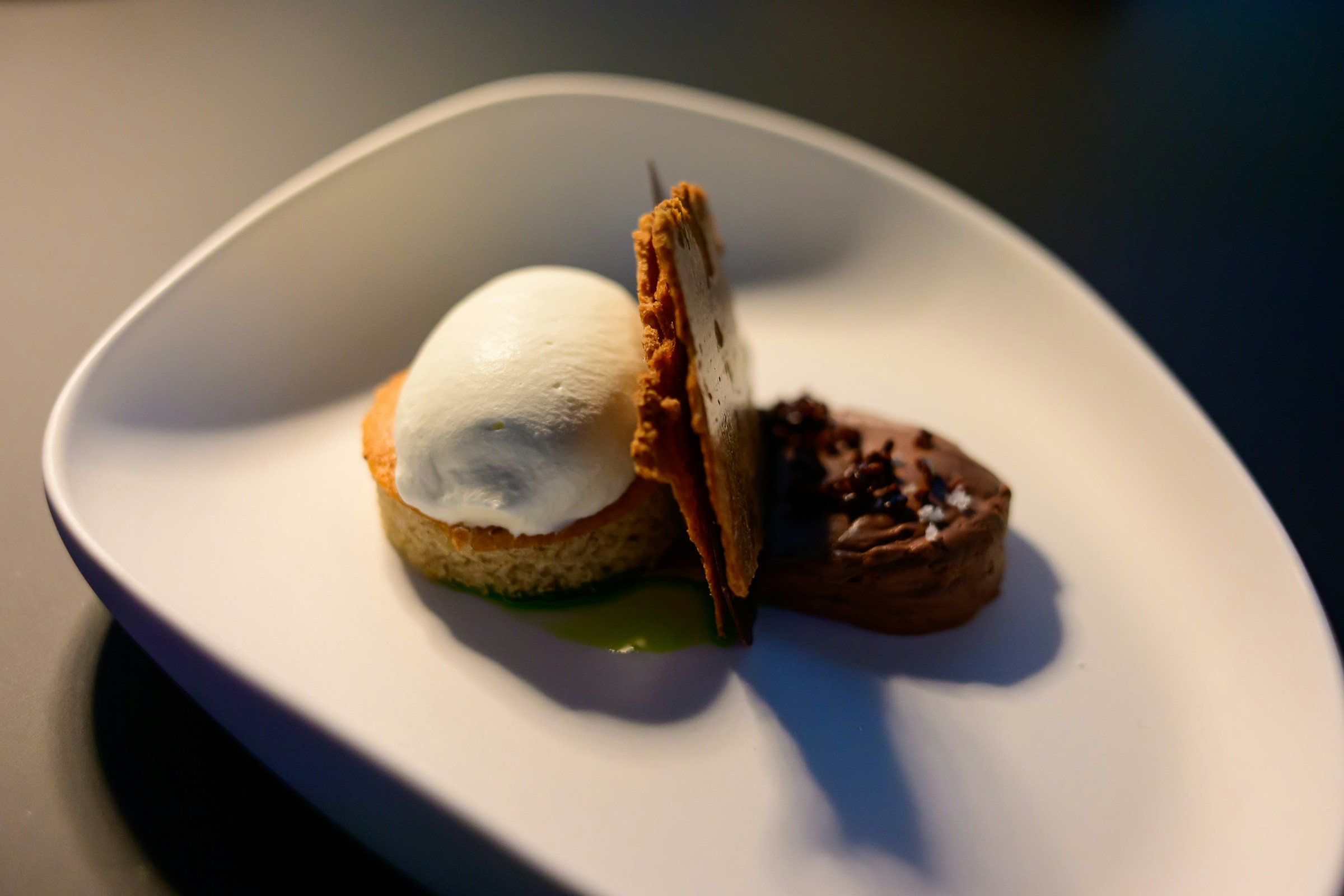 A composed dessert course on a restaurant table in Paris