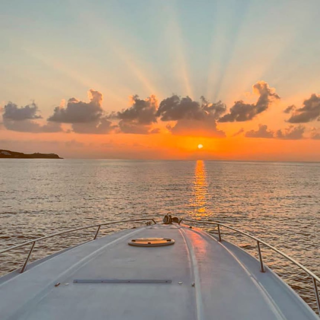Boat at sunset on calm water