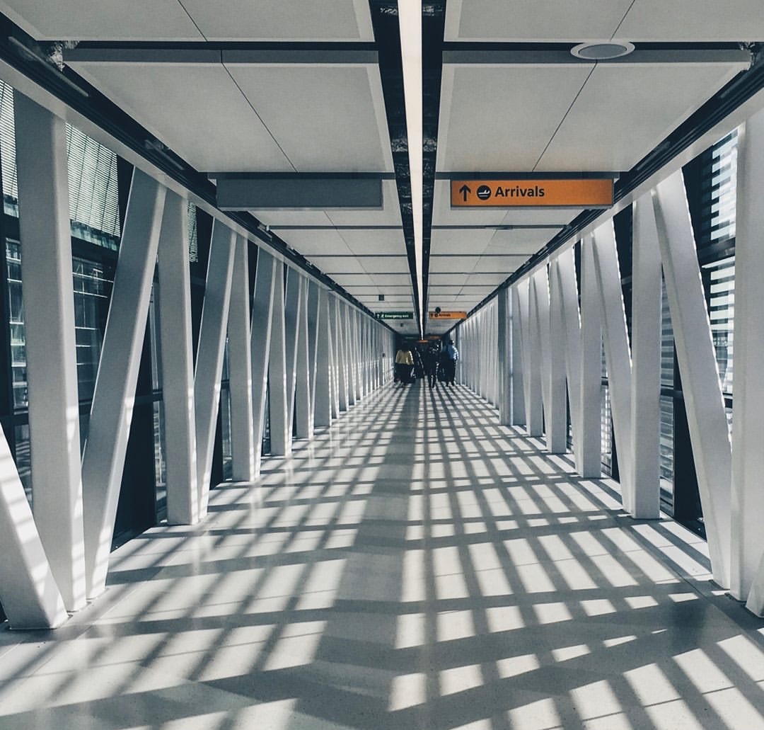 Airport arrivals corridor with travelers in the distance