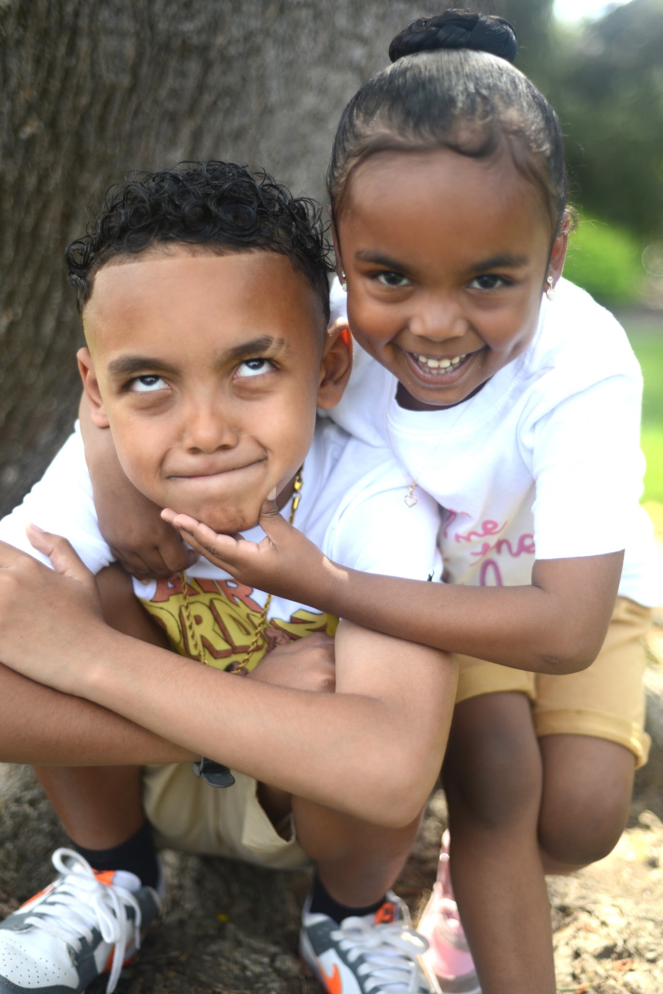 Two children sharing a playful moment outdoors
