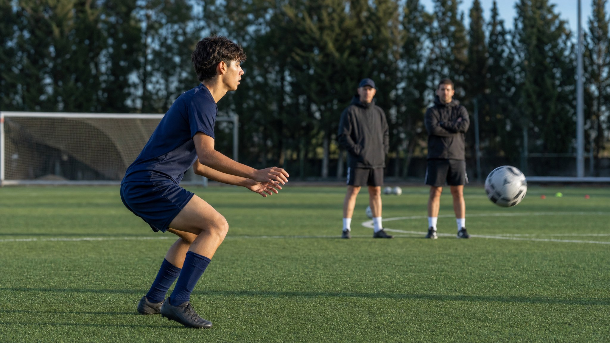Student-athlete preparing to receive a soccer ball during an academy tryout