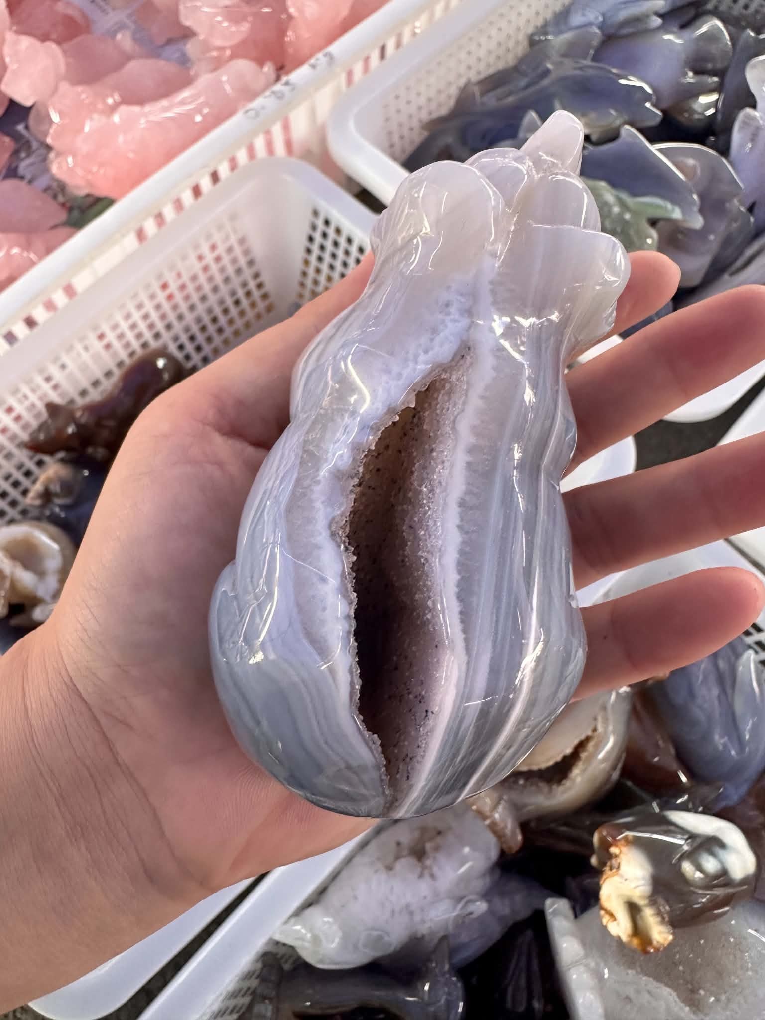 Pale crystal carving held in a hand