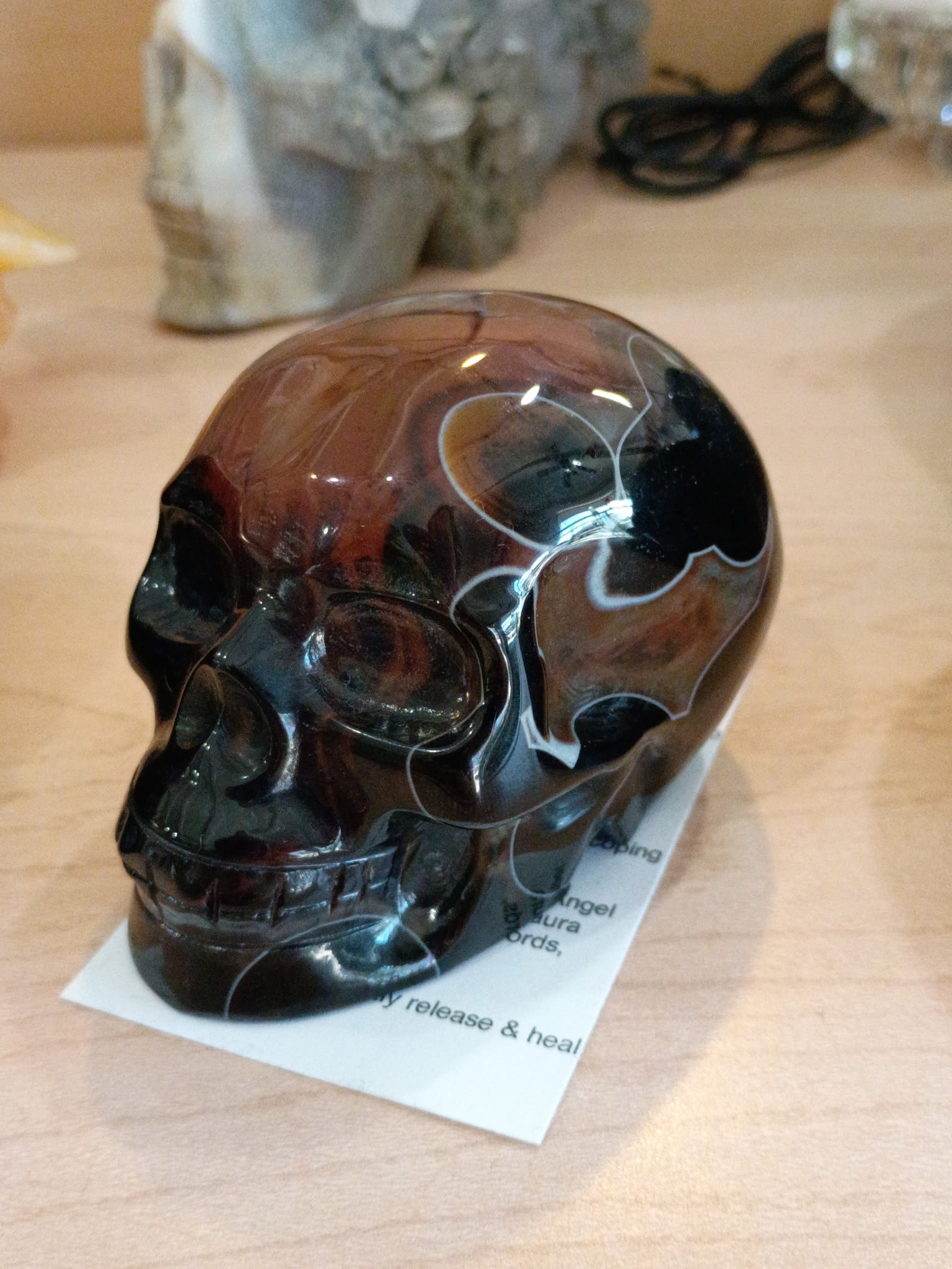 Polished dark stone skull carving