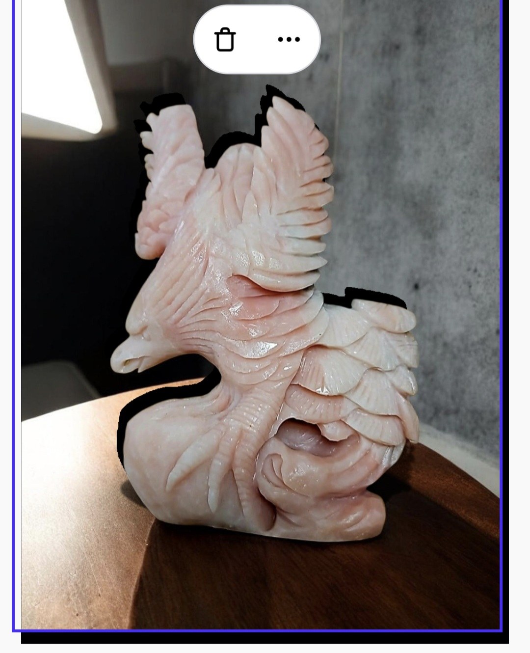 Pink winged stone carving
