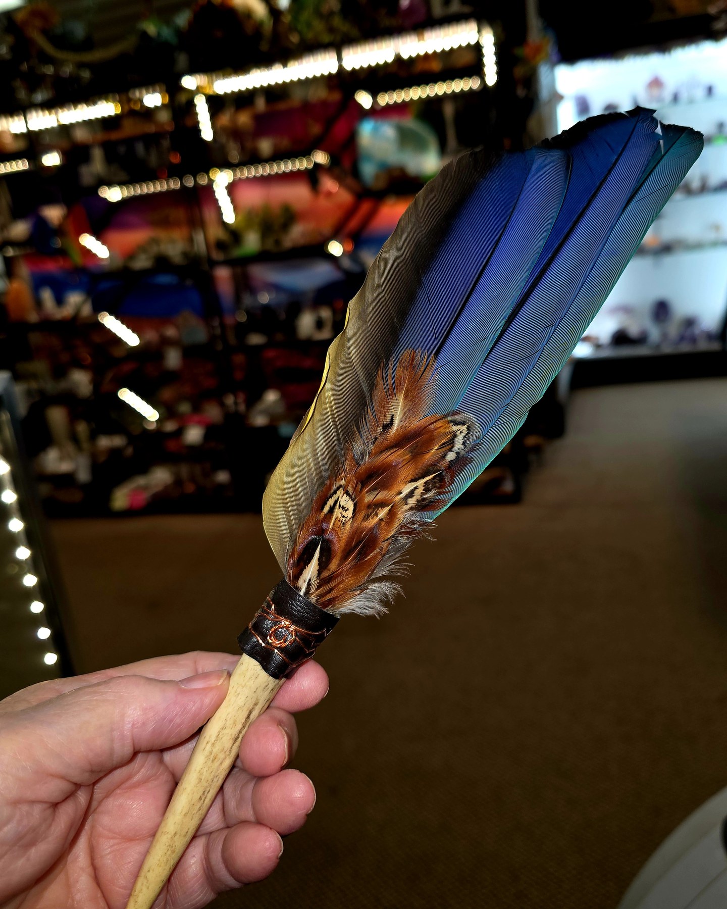 Decorative feather fan held at Roxy’s Rock Shop
