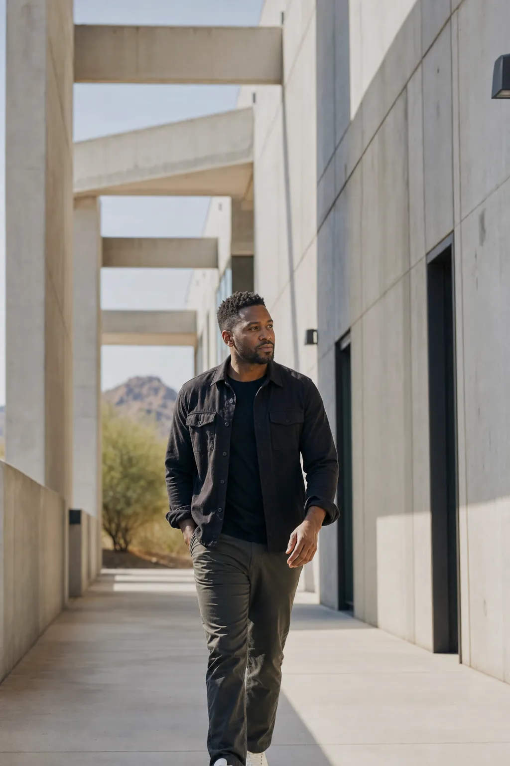 A performance professional walking through a Phoenix architectural corridor