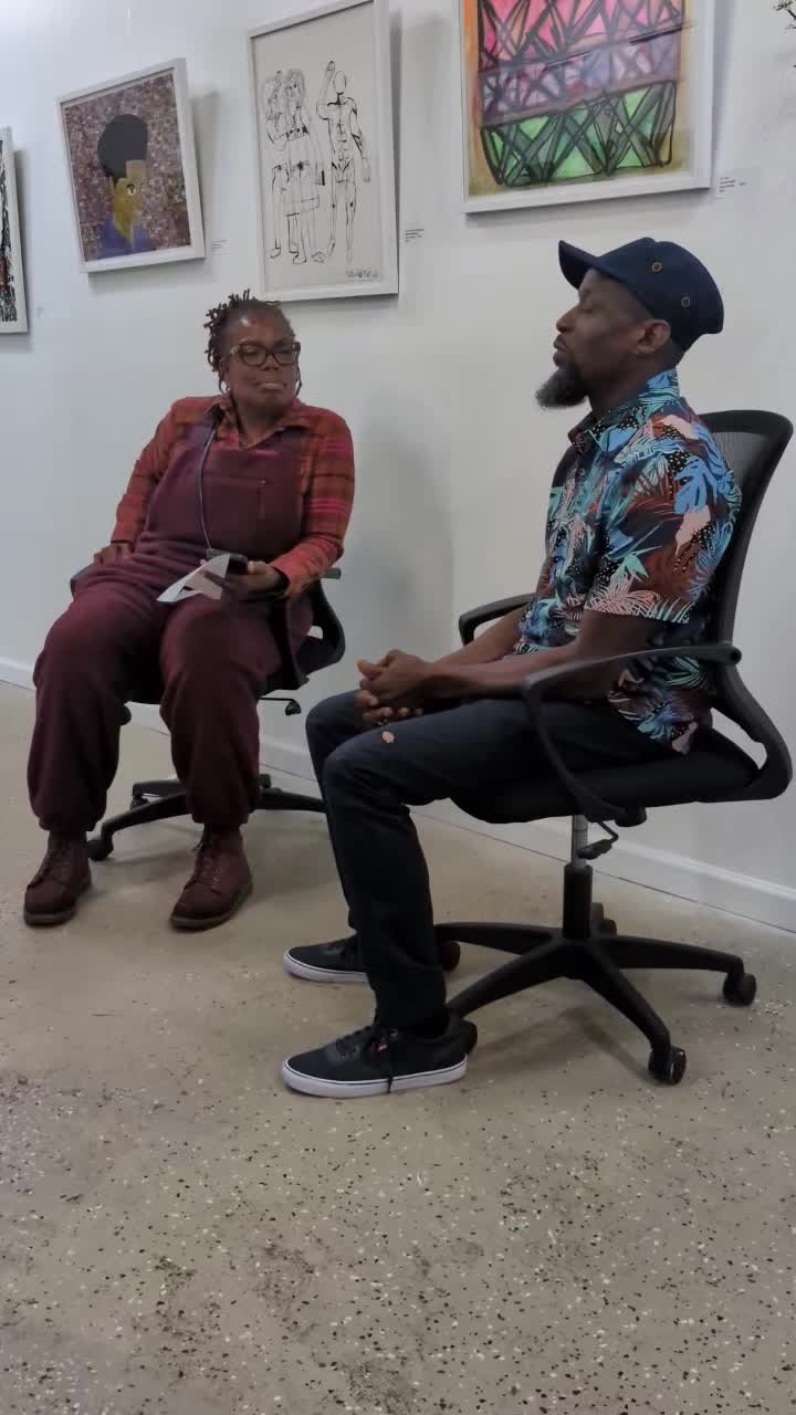 Dawud Shabazz seated in conversation in a gallery