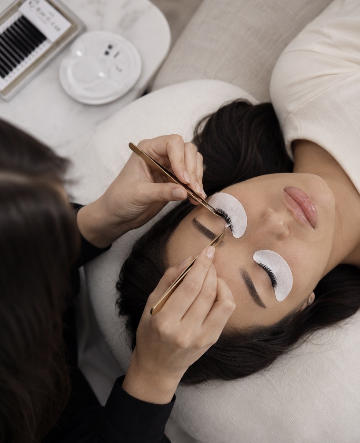 Lash artist applying individual lash extensions to a client