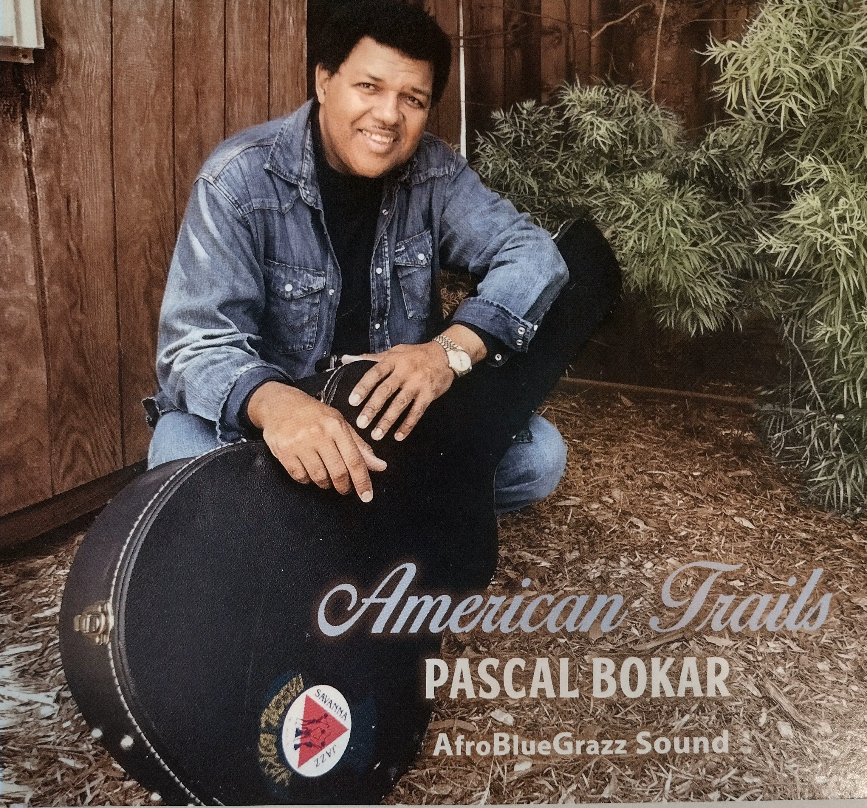 Pascal Bokar on the cover of American Trails with a guitar case